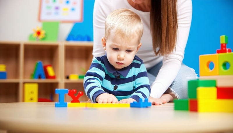 Child engaging in ABA therapy session with a therapist Child engaging in ABA therapy session with a therapist